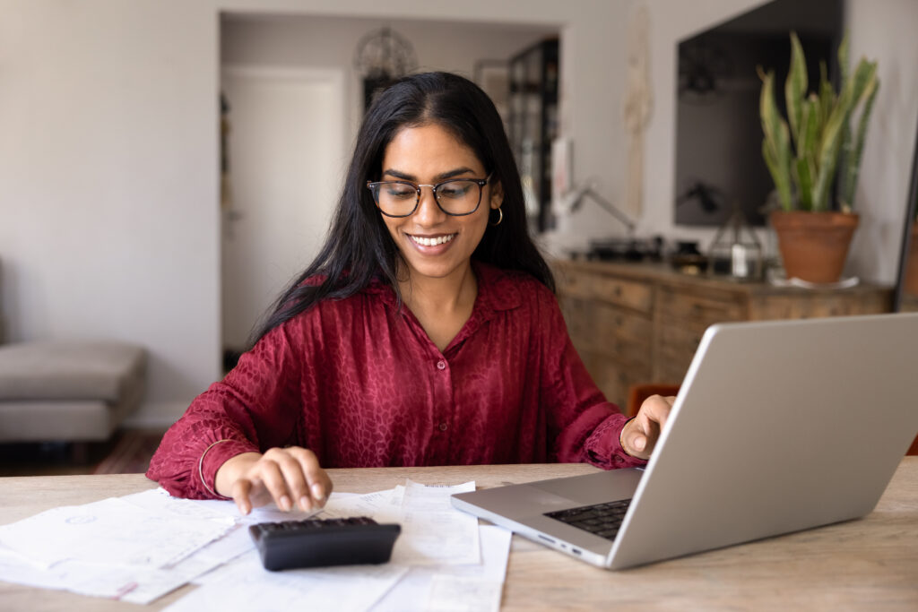 Woman calculating household budget and managing expenses