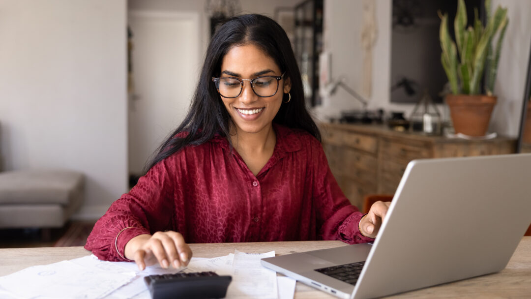 Woman calculating household budget and managing expenses
