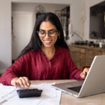 Woman calculating household budget and managing expenses