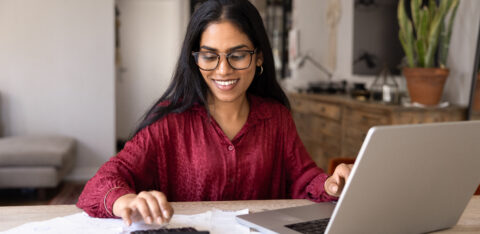 Woman calculating household budget and managing expenses