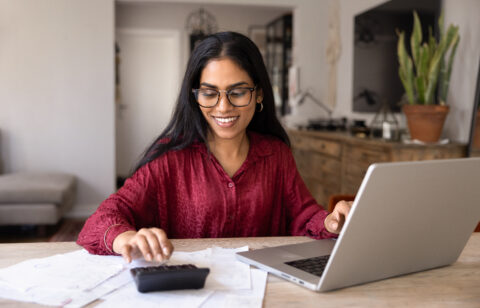 Woman calculating household budget and managing expenses